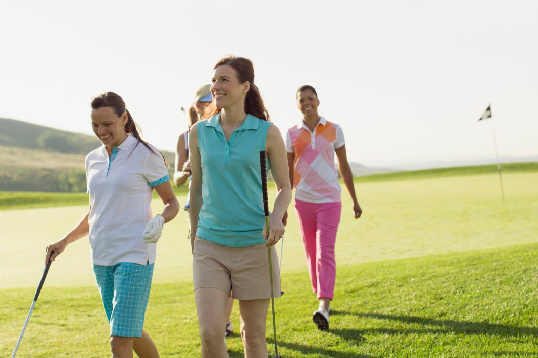 Image of four women golfers walking off green