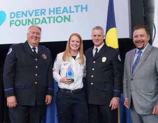 Paramedic Coco Wham receives her Employee of the Year Award from Chief Gary Bryskiewicz, Deputy Chief of Operations Brent Stevenson, and event co-chair Christian P. Anschutz at the 5th Annual Paramedics Awards Celebration